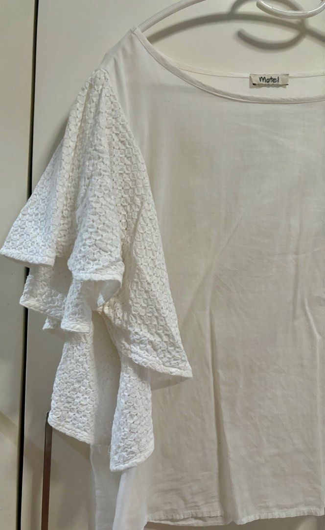 White blouse with eyelet sleeves (Category: Blouses) located in Pasig City. Submitted by aac2021 (Listing ID 1322558125, Image 2). Description: RFS: Decluttering Dimension : Bustline - 40 inches Length - 22 inches Need wash, stored in the cabinet .