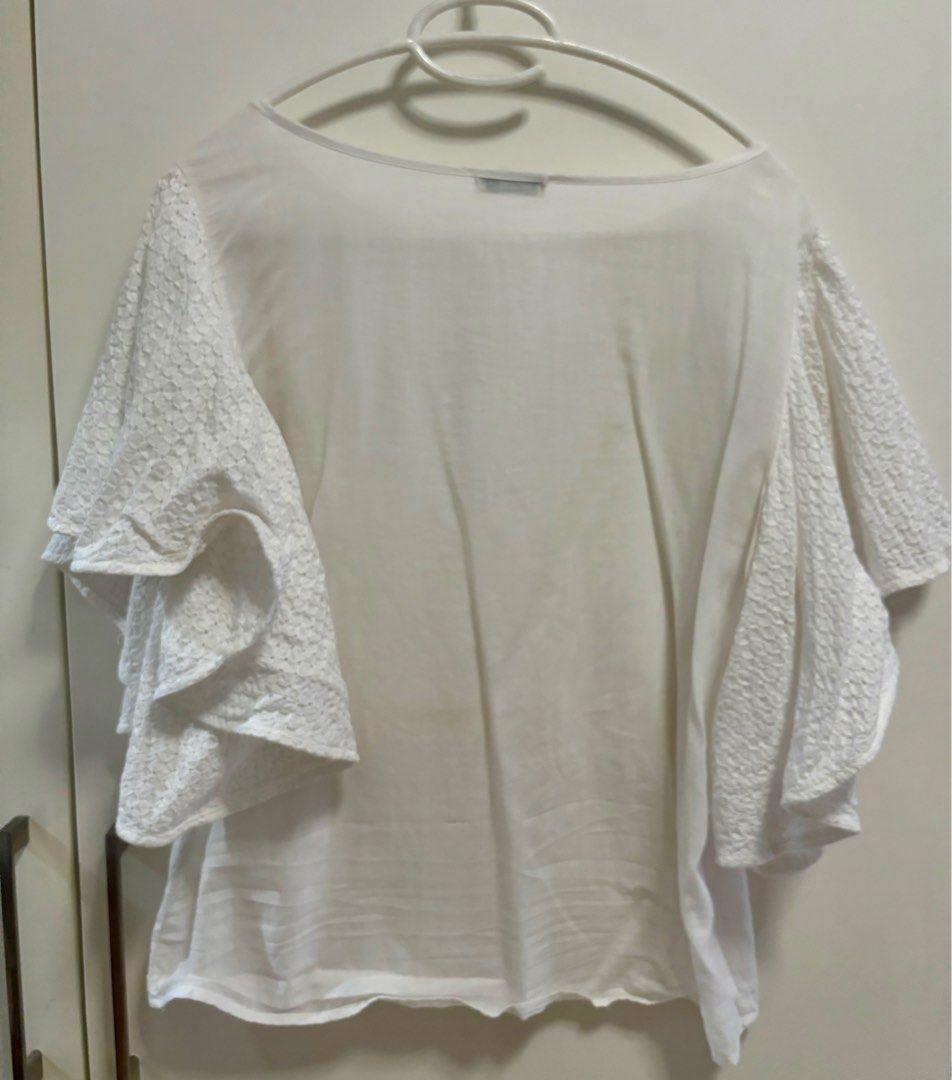 White blouse with eyelet sleeves (Category: Blouses) located in Pasig City. Submitted by aac2021 (Listing ID 1322558125, Image 3). Description: RFS: Decluttering Dimension : Bustline - 40 inches Length - 22 inches Need wash, stored in the cabinet .