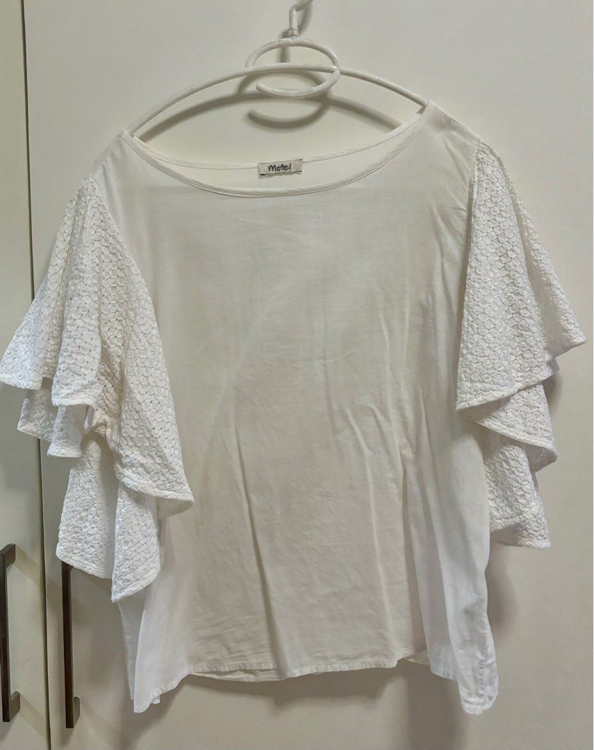 White blouse with eyelet sleeves (Category: Blouses) located in Pasig City. Submitted by aac2021 (Listing ID 1322558125, Image 1). Description: RFS: Decluttering Dimension : Bustline - 40 inches Length - 22 inches Need wash, stored in the cabinet .