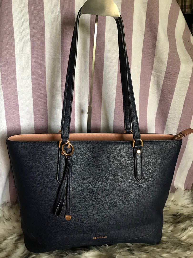 Beanpole Tote Bag (Category: Luxury Bags & Wallets) located in Muntinlupa City. Submitted by rina.rina3 (Listing ID 1322931793, Image 1). Description: Like new dark blue Beanpole tote bag Sourced from Korea Very excellent leather and gold hardwares Rivets and bay charm have Beanpole engravings Bag dimensions all in inches, LXWXH 17in x 6in x 10.5 Bag total height including handles is 21in Slightly negotiable Buyer to shoulder shipping fee .