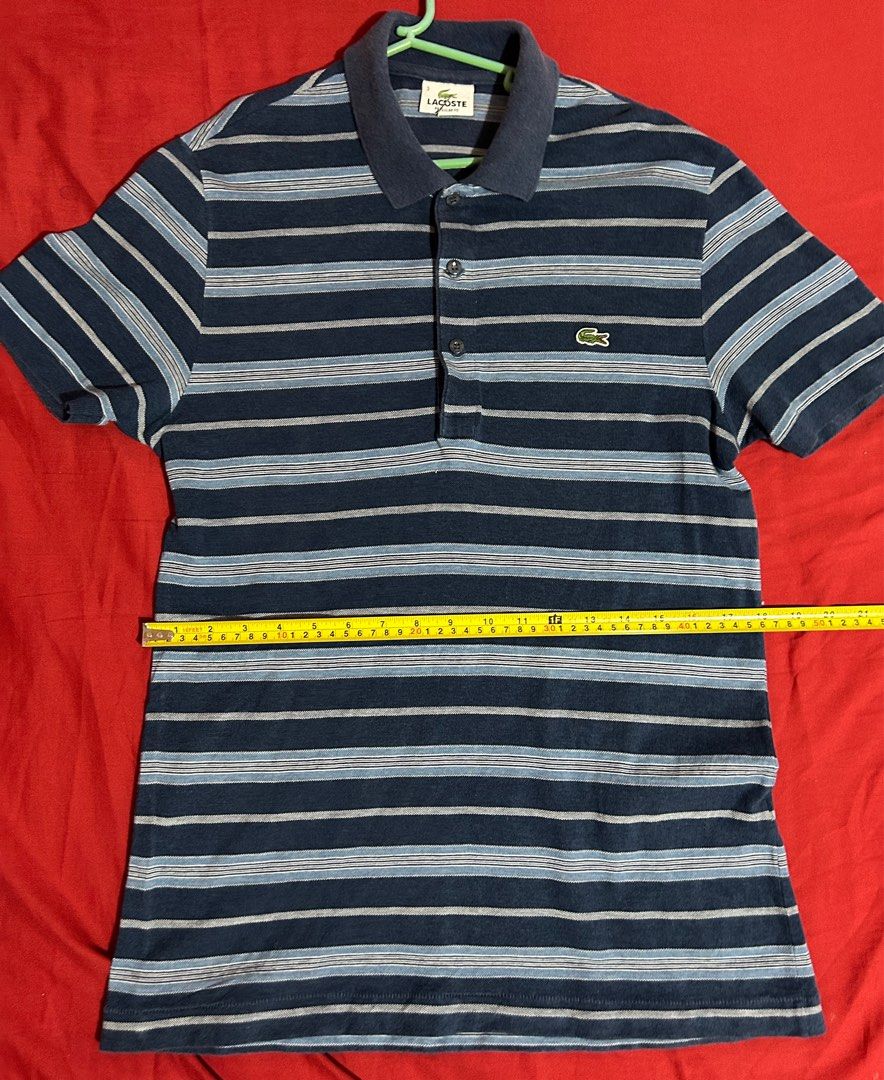 LACOSTE POLO SHIRT (original) (Category: Tshirts & Polo Shirts ) located in San Ildefonso. Submitted by PatchAdamss (Listing ID 1323010297, Image 2). Description: For sale!!! LACOSTE POLO SHIRT (original) Blue stripes No holes No fades Presentable 9/10 condition Only issue may small cut s neck tag.