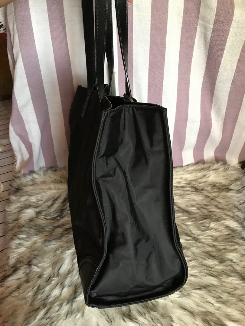 Oryany Large Black Tote Bag (Category: Luxury Bags & Wallets) located in Muntinlupa City. Submitted by rina.rina3 (Listing ID 1322929584, Image 3). Description: Preowned black Oryany tote bag from Korea Like new condition Lightweight but very durable Snap closure With 2 open pockets and 2 zippered pockets inside With very nice leather tassels Bag dimensions all in inches, LXWXH 15.5in x 6.5in x 12in Bag height including top handle is 21in approx.