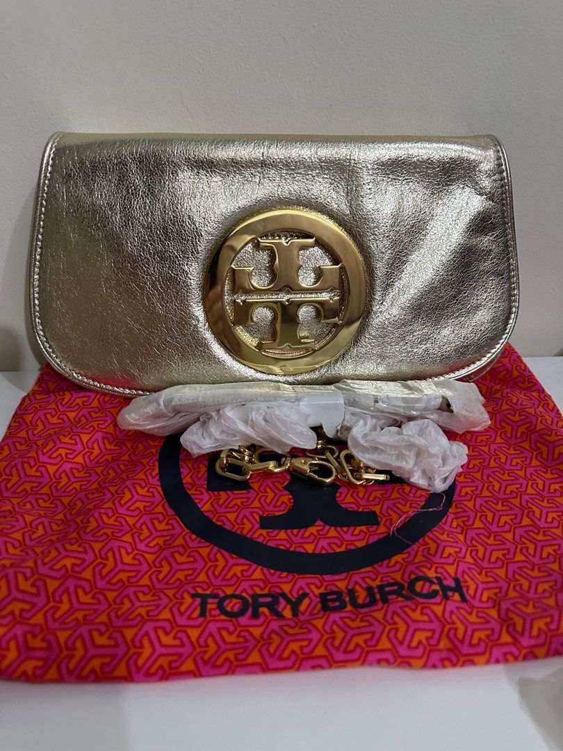 Tory Burch Reva Gold Clutch (Category: Luxury Bags & Wallets) located in San Juan City. Submitted by b.ocampo (Listing ID 1323048738, Image 3). Description: - Tory Burch Reva Clutch (Gold) - Brand new, authentic - Includes chain strap and dust bag - Original price: 29,250 PHP .