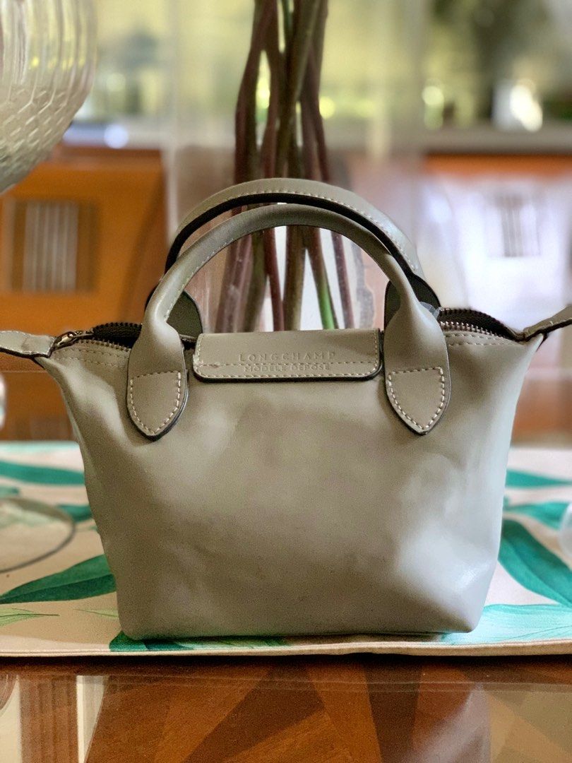 Longchamp Micro Bag / Authentic (Category: Luxury Bags & Wallets) located in Guagua. Submitted by rizza4 (Listing ID 1318091288, Image 2). Description: • Lambskin genuine leather • rubber lining intact • no sign of usage • no sling • minor issue na fold lang sa box • silver hardware.