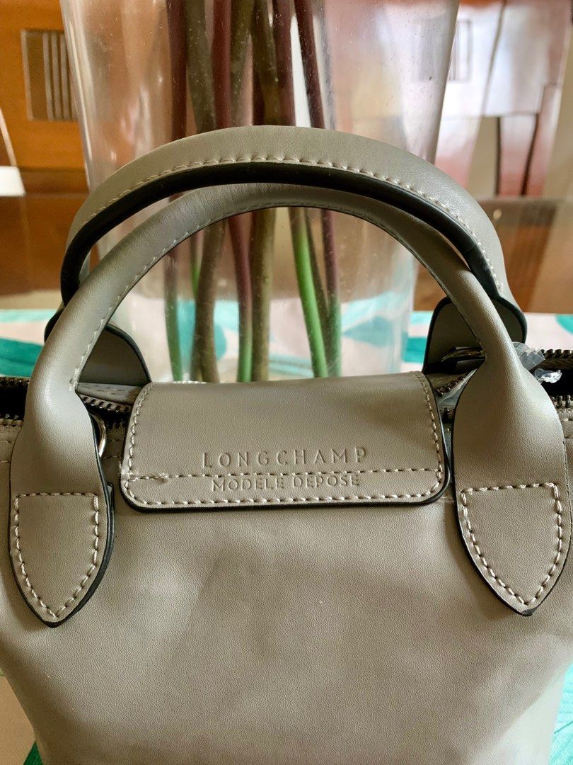 Longchamp Micro Bag / Authentic (Category: Luxury Bags & Wallets) located in Guagua. Submitted by rizza4 (Listing ID 1318091288, Image 3). Description: • Lambskin genuine leather • rubber lining intact • no sign of usage • no sling • minor issue na fold lang sa box • silver hardware.