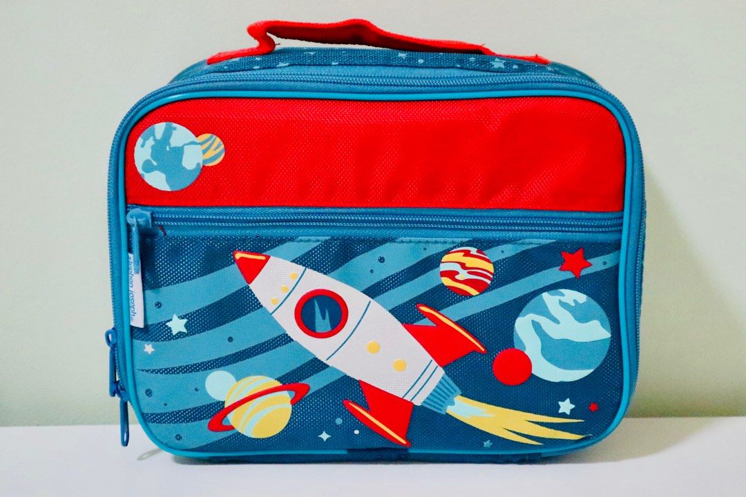 Stephen Joseph Classic Lunch Bag for Boys (Category: Babies & Kids Fashion) located in Malolos. Submitted by oneflightdown (Listing ID 1318136129, Image 1). Description: Get your little one’s lunch all packed up and ready to go with a Stephen Joseph Classic Lunchbox. - Inner mesh pocket. - Drink fastener. - Front zipper pocket - Screen printed designs with puff ink accents - Fully insulated with waterproof PEVA lining - Approx. 10” x 7.5”x 3” (25