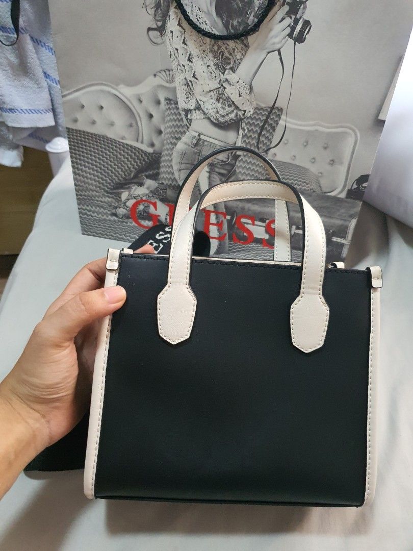 Guess Mini Tote Bag (Category: Luxury Bags & Wallets) located in Paranaque City. Submitted by monsalvemarielle08 (Listing ID 1318266823, Image 3). Description: Original Guess Mini Tote Bag only used twice. RFS: too small for my preferrence and decluttering 😊 minor issue: see last pic PM me if you want more pics of the bag and still negotiable.