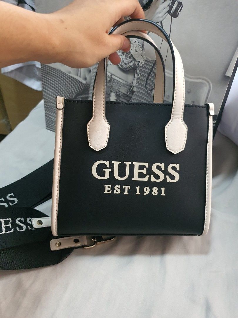 Guess Mini Tote Bag (Category: Luxury Bags & Wallets) located in Paranaque City. Submitted by monsalvemarielle08 (Listing ID 1318266823, Image 2). Description: Original Guess Mini Tote Bag only used twice. RFS: too small for my preferrence and decluttering 😊 minor issue: see last pic PM me if you want more pics of the bag and still negotiable.
