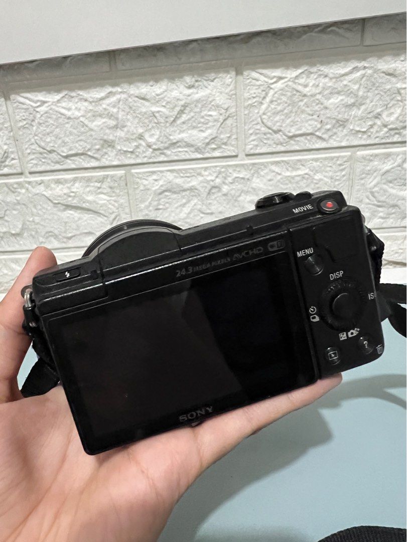 Sony Mirrorless A5100 Camera Body and Lens (Category: Cameras) located in Manila. Submitted by prelovedbyaiah (Listing ID 1318416890, Image 2). Description: Comes with charger cord and box Honest issue: No Lens cover, minimal crack (unnoticeable, doesnt affect photo output) RFS: Decluttering, not used .