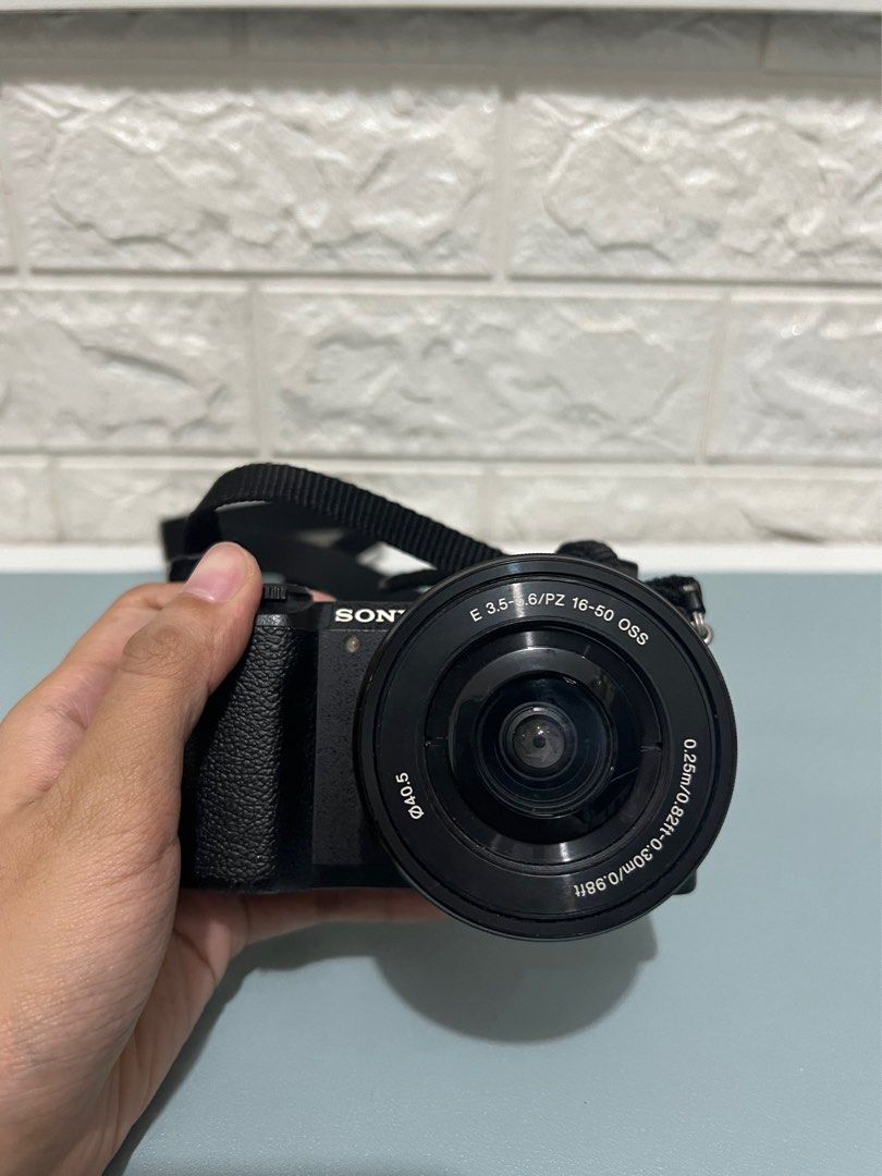 Sony Mirrorless A5100 Camera Body and Lens (Category: Cameras) located in Manila. Submitted by prelovedbyaiah (Listing ID 1318416890, Image 3). Description: Comes with charger cord and box Honest issue: No Lens cover, minimal crack (unnoticeable, doesnt affect photo output) RFS: Decluttering, not used .