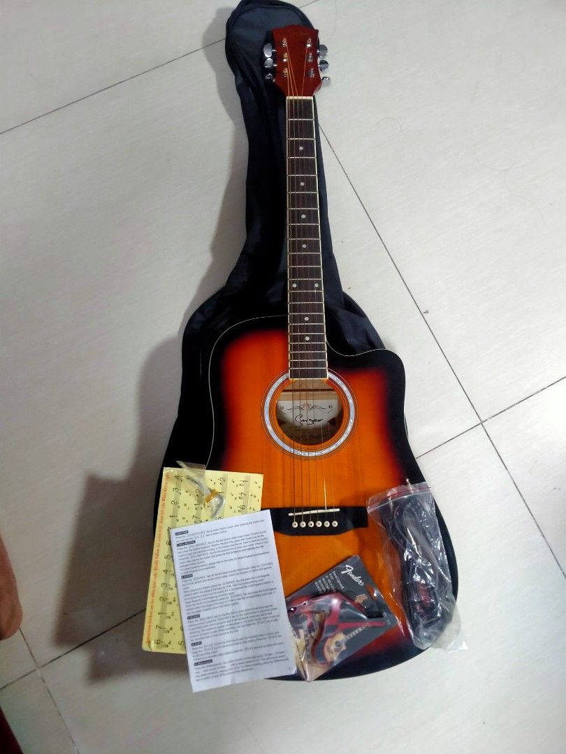 Acoustic Guitar (Category: Musical Instruments) located in Las Pinas. Submitted by elitecomputer (Listing ID 1318460553, Image 2). Description: Acoustic Guitar with bag, cord, kapo, pick. di pa po nagagamit. naka stock lang.