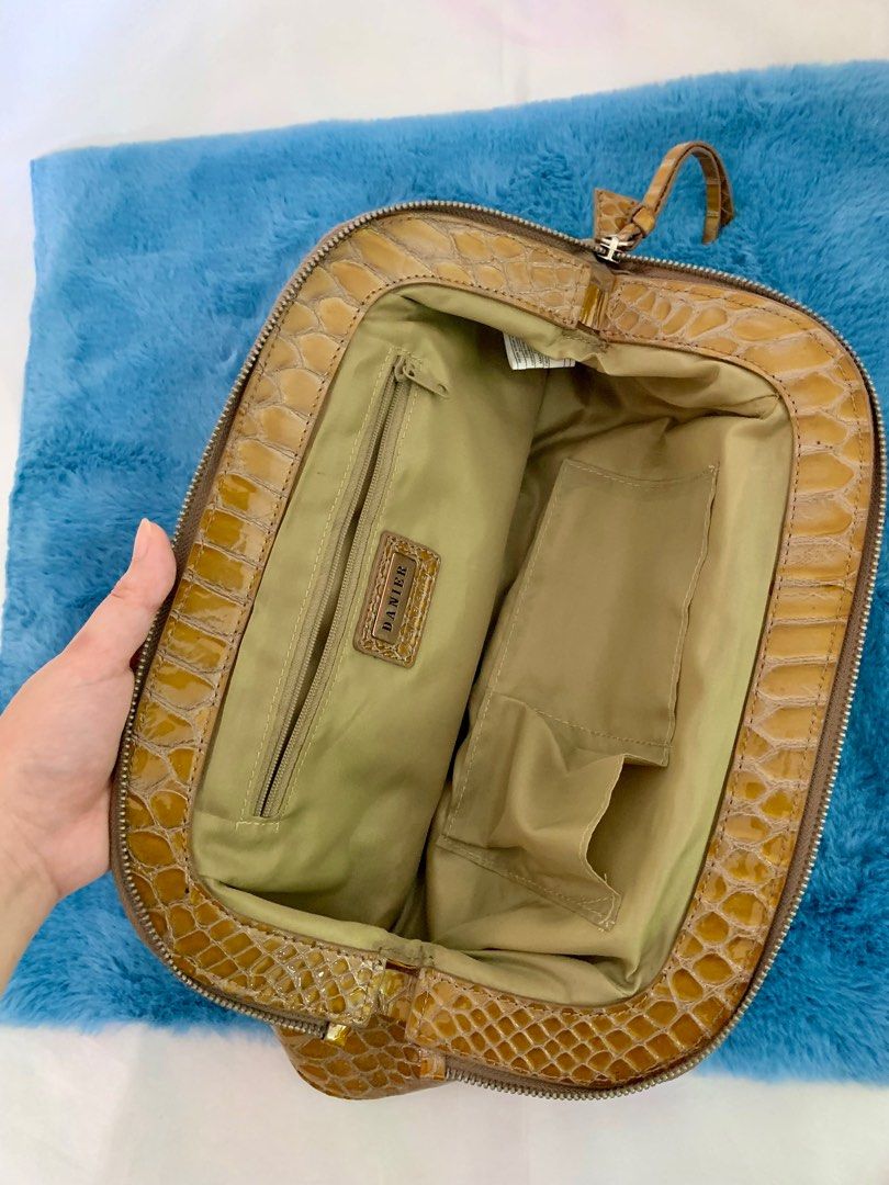 Danier Snakeskin Chain Purse Vintage Classy Shoulder Bag (Category: Luxury Bags & Wallets) located in Manila. Submitted by midcloset (Listing ID 1318606188, Image 2). Description: Does not come with original packaging. 👜 FEATURES: • Lightweight and durable • Stain and water-resistant • 2 pockets and 1 zip-pocket inside bag • Silver chain strap and detailing • Genuine leather • Shiny finish • Snakeskin-like appearance.
