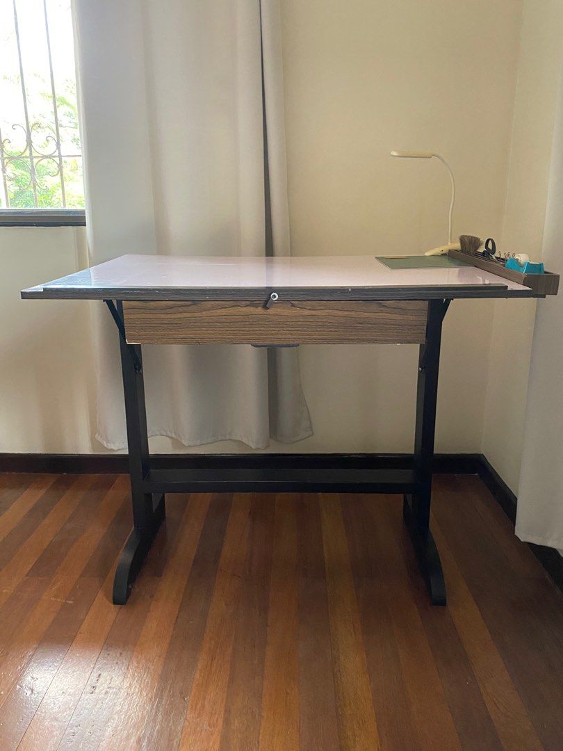 Drafting Table (30in x 40in) (Category: Tables & Sets) located in Makati City. Submitted by acdcinmyblood (Listing ID 1318681838, Image 1). Description: - LxW: 30in x 40in - Includes adjustable incline and many compartments for rulers, pens, tape, etc (see photos) - Will include LAMP + CLIPS - Solid steel frame with no broken parts - Just the right size so it doesn’t take up too much space in my room either Can be bought as a set with other start