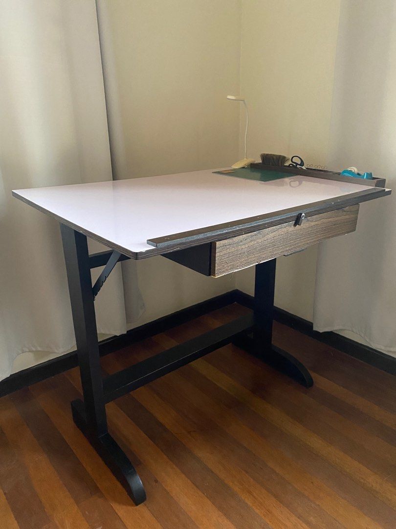 Drafting Table (30in x 40in) (Category: Tables & Sets) located in Makati City. Submitted by acdcinmyblood (Listing ID 1318681838, Image 2). Description: - LxW: 30in x 40in - Includes adjustable incline and many compartments for rulers, pens, tape, etc (see photos) - Will include LAMP + CLIPS - Solid steel frame with no broken parts - Just the right size so it doesn’t take up too much space in my room either Can be bought as a set with other start