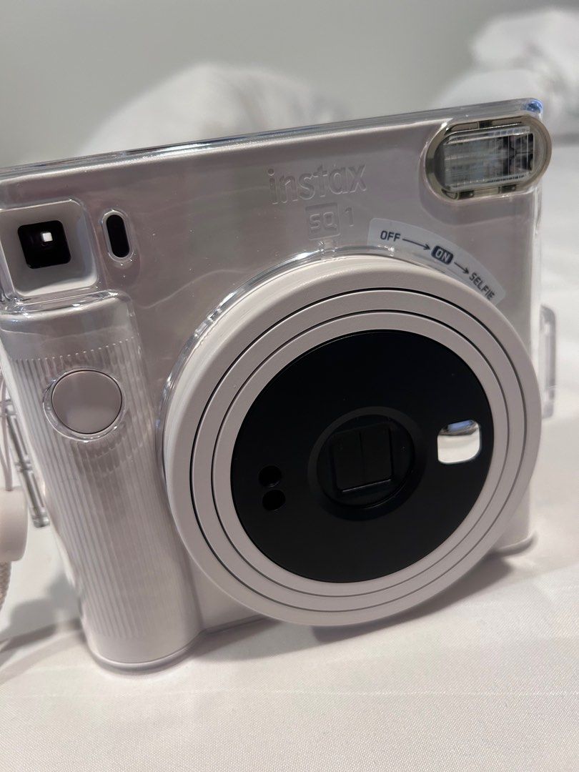 Instax Square SQ1 Instant Film Camera (Category: Cameras) located in Manila. Submitted by lynn901110 (Listing ID 1318627651, Image 1). Description: Used once Bought in May Including - battery - strap - clear casing - 7’s Instax square film - 1x thumb grip attachment - SF borne by buyer.
