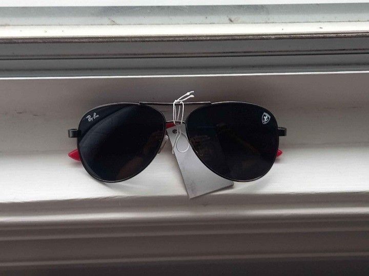 Ray-Ban x Ferrari Sunglasses (Category: Luxury) located in Toronto. Submitted by dervinjan189299 (Listing ID 1318791353, Image 3). Description: Brand New, Beautiful Quality & Excellent Condition Comes With Wipe Cloth & Is In Its Original Packaging Includes The Ferrari Logo As Shown In The Pictures.