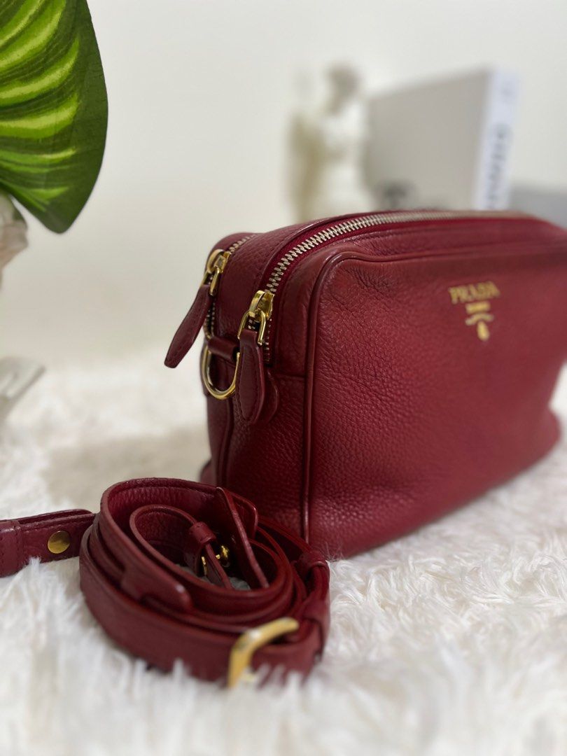 Prada Vitello Phenix Camera Bag Rubino (Category: Luxury Bags & Wallets) located in Pasig City. Submitted by r.m.c2 (Listing ID 1318928528, Image 2). Description: Prada Vitello Phenix Camera Bag Rubino 100% Authentic Bag only RFS: Decluttering MOP: GCash or BPI.