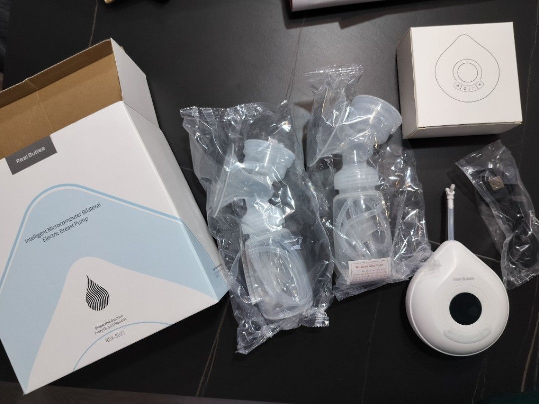 Real Bubee Breast Pump (Category: Breastfeeding & Bottle Feeding) located in Singapore. Submitted by escapesequence (Listing ID 1318891663, Image 1). Description: Breast pump with box available. Only machine used. 1 flange packet was opened to retrieve the small 'Y' connecting tube..