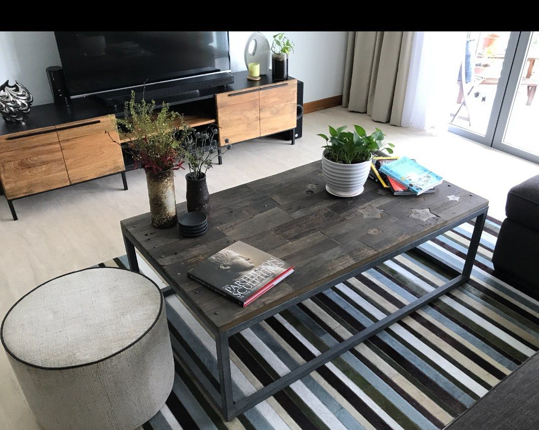 Coffee table (Category: Tables & Sets) located in Singapore. Submitted by phil83 (Listing ID 1323095261, Image 1). Description: This is a reclaimed solid oak top made from several reclaimed floor boards. It has iron rivets pinning the wood to a pitted steel frame. The top has been treated to reflect a distressed wood style. It has several metal stars set in to the top as a detail feature. The stars are iron so designed to tarnish as part of the i