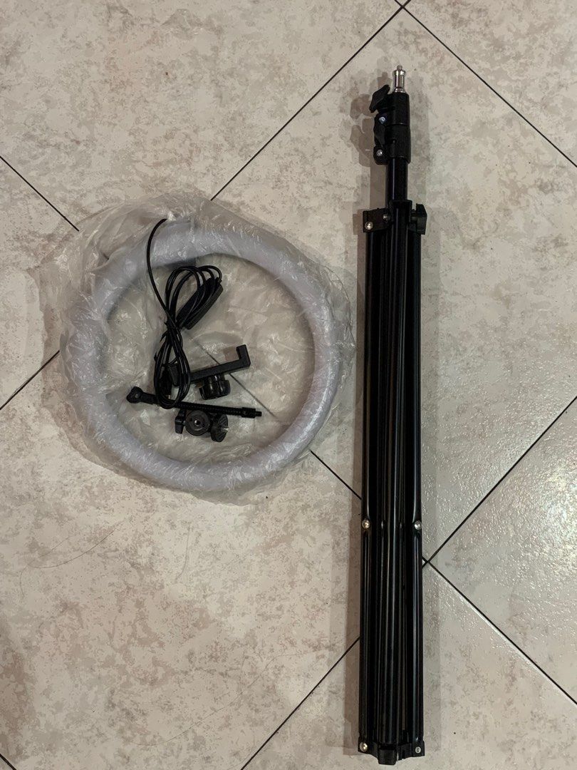 Ring light with phone holder (Category: Tripods & Monopods) located in Quezon City. Submitted by jaianaapura (Listing ID 1324946228, Image 1). Description: Brandnew high quality. Stand can be extended .