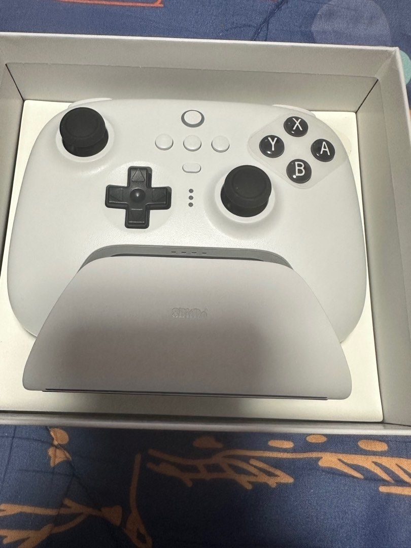 8BitDo Ultimate Bluetooth Controller (Category: Controllers) located in Singapore. Submitted by ryang1809 (Listing ID 1325516488, Image 2). Description: 8BitDo Ultimate Bluetooth Controller for sale. Comes with charging dock and 2.4G Dongle receiver. Used only once. In pristine condition..