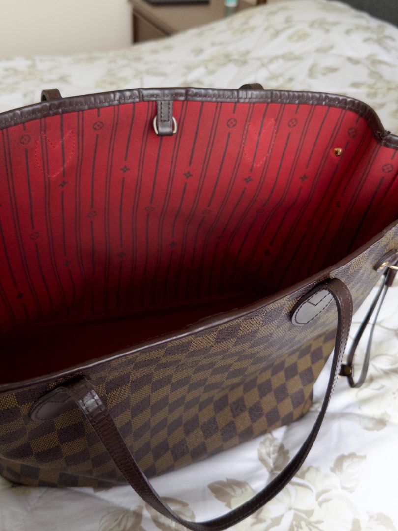 LOUIS VUITTON never full MM bag (Category: Luxury Bags & Wallets) located in Quezon City. Submitted by sofiasellsstuff (Listing ID 1325506518, Image 3). Description: 💯 AUTHENTIC brand: LOUIS VUITTON size: 12.2 x 11 x 5.5 inches color: cerise Red material: Damier Ebene coated canvas, natural cowhide-leather trim details: striped textile lining, gold hardware, 4 side laces closure: hook closure features: flat, textile-lined zipped inside pocket, D