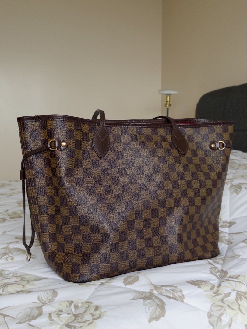 LOUIS VUITTON never full MM bag (Category: Luxury Bags & Wallets) located in Quezon City. Submitted by sofiasellsstuff (Listing ID 1325506518, Image 1). Description: 💯 AUTHENTIC brand: LOUIS VUITTON size: 12.2 x 11 x 5.5 inches color: cerise Red material: Damier Ebene coated canvas, natural cowhide-leather trim details: striped textile lining, gold hardware, 4 side laces closure: hook closure features: flat, textile-lined zipped inside pocket, D