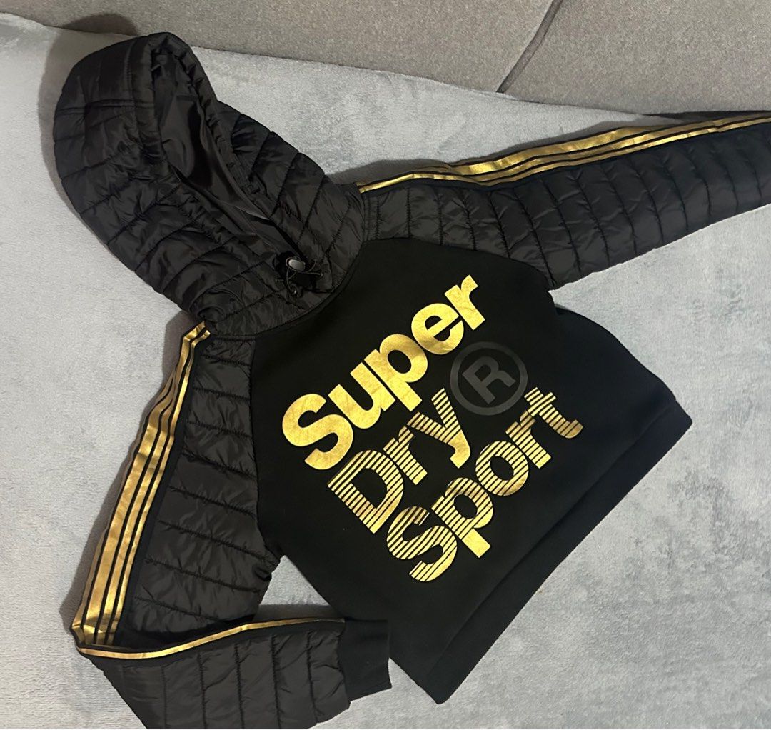 Superdry | Black & Gold Hoddie (Category: Coats, Jackets and Outerwear) located in San Fernando. Submitted by km_koleksyon (Listing ID 1325449683, Image 1). Description: Superdry | Sport Gold Black & Gold Hoddie Gmytech edition Lightly used Size on tag - uk14/us10/eu42 .