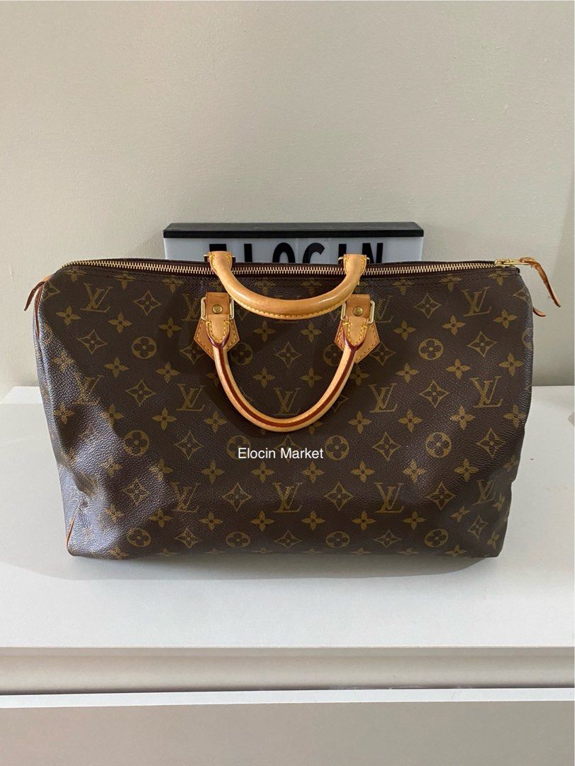 LOUIS VUITTON Monogram Speedy 40 Handbag (Category: Luxury Bags & Wallets) located in Bacoor. Submitted by elocinmarket (Listing ID 1325675294, Image 1). Description: LOUIS VUITTON Monogram Speedy 40 Handbag - Gold-tone hardware - Brown monogram coated canvas - Dual rolled top handles - Tan vachetta leather trim - Brown canvas lining with single interior pocket - Vintage Overall Preloved Condition: Very Good. Exterior Condition: Very Good. Discol