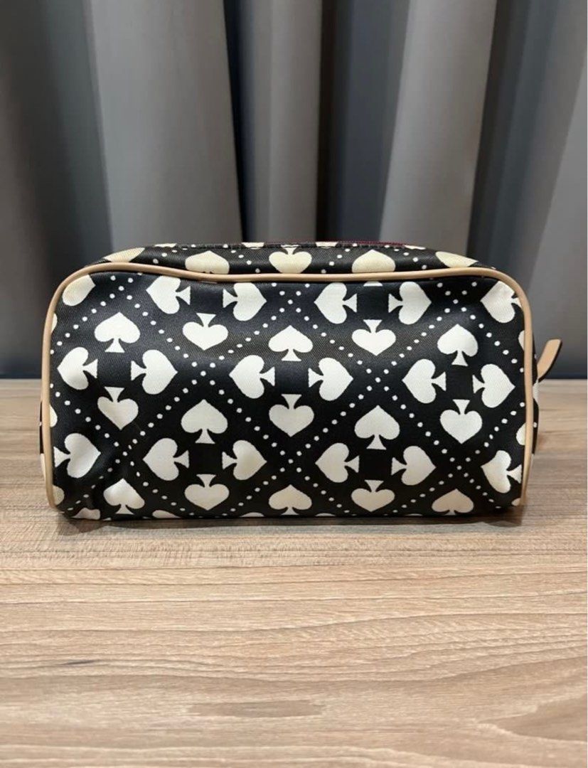Kate Spade canvas cosmetic pouch (Category: Luxury Bags & Wallets) located in Muntinlupa City. Submitted by trishlovessales (Listing ID 1325956848, Image 3). Description: Bought this on Carousell. Authentic Kate Spade. Comes with care card and tag. Shows signs of usage. Black Color looks slightly faded. Interior is bright red, slightly dirty, may need cleaning. .