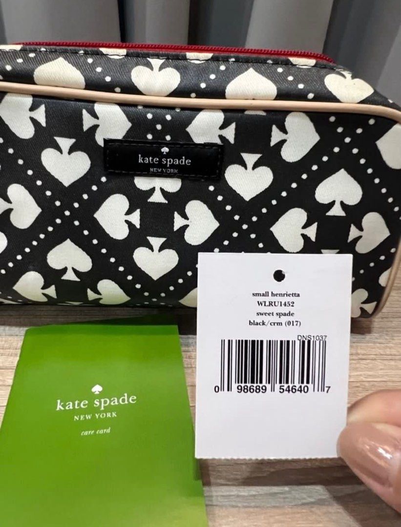 Kate Spade canvas cosmetic pouch (Category: Luxury Bags & Wallets) located in Muntinlupa City. Submitted by trishlovessales (Listing ID 1325956848, Image 2). Description: Bought this on Carousell. Authentic Kate Spade. Comes with care card and tag. Shows signs of usage. Black Color looks slightly faded. Interior is bright red, slightly dirty, may need cleaning. .