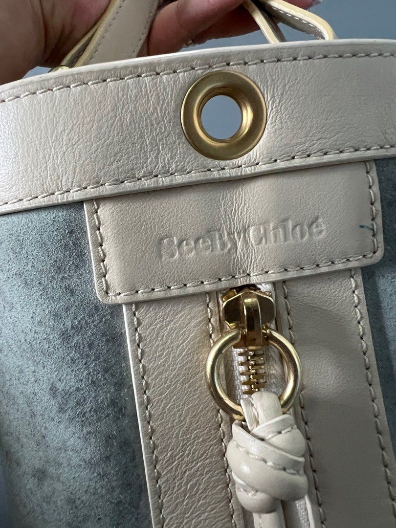 See by Chloe Bucket bag (Category: Luxury Bags & Wallets) located in Quezon City. Submitted by lesgosago (Listing ID 1326444801, Image 2). Description: 💯 Authentic See by Chloe bucket bag In rare baby blue and white Has tags and code plus an intact holo. Inside is very clean. Bag only, as is. Issues: has water(?) marks and small penmarks, needs bag spa. MOP: Gcash/BPI MOD: sdd/lbc.