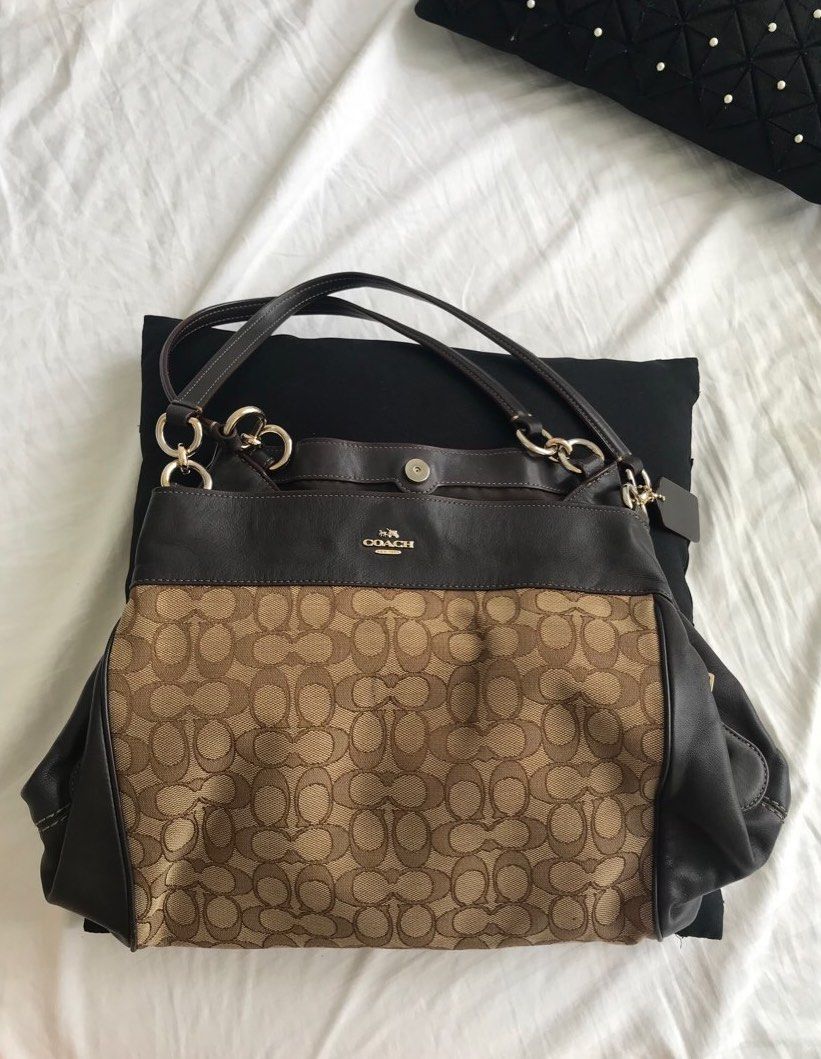 Coach Black and Brown Leather Shoulder Bag (Category: Luxury Bags & Wallets) located in Makati City. Submitted by laineycops (Listing ID 1323347815, Image 1). Description: 4 compartments min. wear and creasing sold as is rfs: fam declutter ***see about on profile.