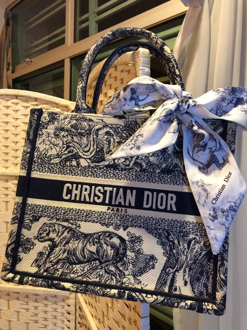Dior book tote (Category: Bags & Wallets) located in Singapore. Submitted by vcsh898921487 (Listing ID 1323388092, Image 1). Description: No stain and used a few times lightly .