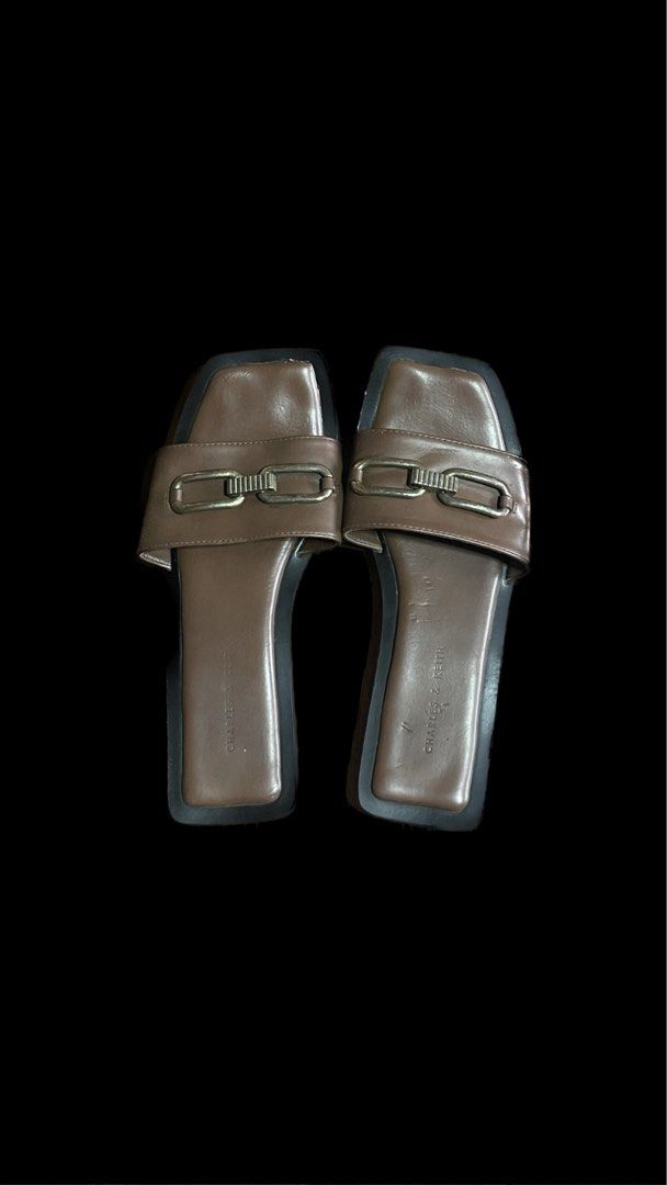 Charles and Keith slip ons (Category: Flats & Sandals) located in Manila. Submitted by praynes (Listing ID 1323345584, Image 1). Description: Well used flat sandals.