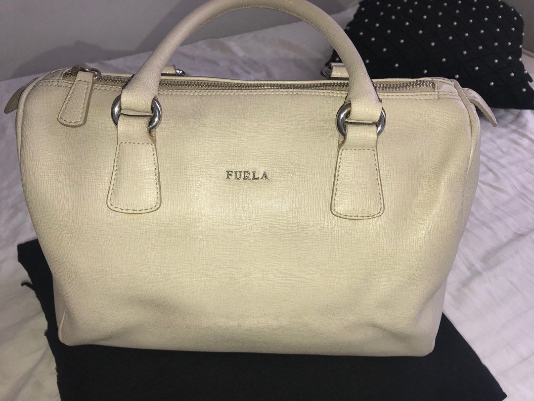 Furla Cream Leather Hand Bag (Category: Luxury Bags & Wallets) located in Makati City. Submitted by laineycops (Listing ID 1323346098, Image 2). Description: min flaw: min wear on the bottom edges, lip stick stain inside sold as is 3 compartments silver hardware genuine leather rfs: fam declutter ***see about on profile.