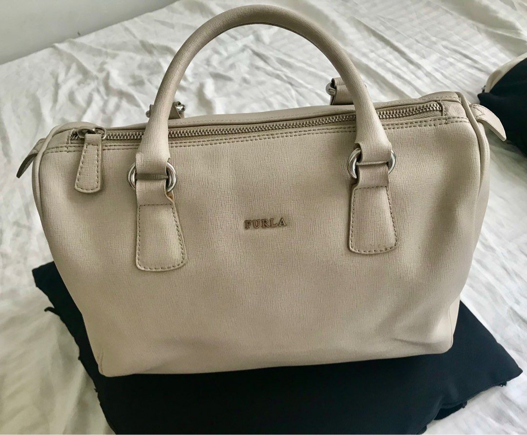 Furla Cream Leather Hand Bag (Category: Luxury Bags & Wallets) located in Makati City. Submitted by laineycops (Listing ID 1323346098, Image 1). Description: min flaw: min wear on the bottom edges, lip stick stain inside sold as is 3 compartments silver hardware genuine leather rfs: fam declutter ***see about on profile.