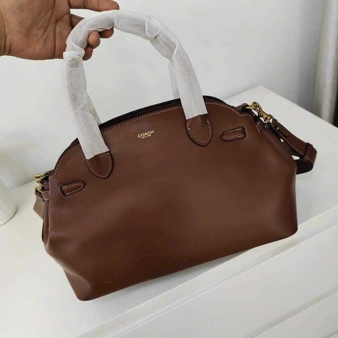 Coach Empire Carryall Bag 28 (Category: Tote Bags) located in Manila. Submitted by stacey_lopez922 (Listing ID 1326499444, Image 2). Description: Coach Empire Carryall Bag 28 (With dustbag and paperbag) - 35.5cm (L) x 21.5cm (H) x 16cm (W) - Glovetanned leather - Inside snap pocket - Center zip compartment - Fabric lining - Handles with 9.5cm drop - Detachable strap with 54.5cm drop for shoulder or crossbody wear - Four protective feet at base.