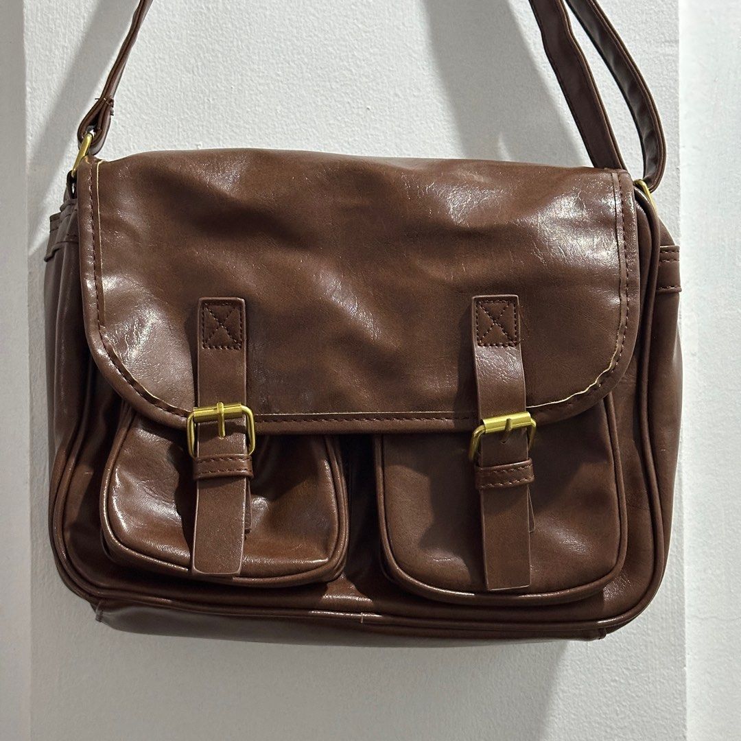 Dark Brown Shoulder/Cross body Bag (Category: Cross-body Bags) located in Binan City. Submitted by srdd_ (Listing ID 1326942928, Image 2). Description: For sale! - in mint condition - no scratches - with adjustable strap - lots of pockets - dust bag included - super nice color - good and convenient when travelling - can fit ipad, books, etc. Rfs: decluttering Mop: gcash / bpi / maribank.