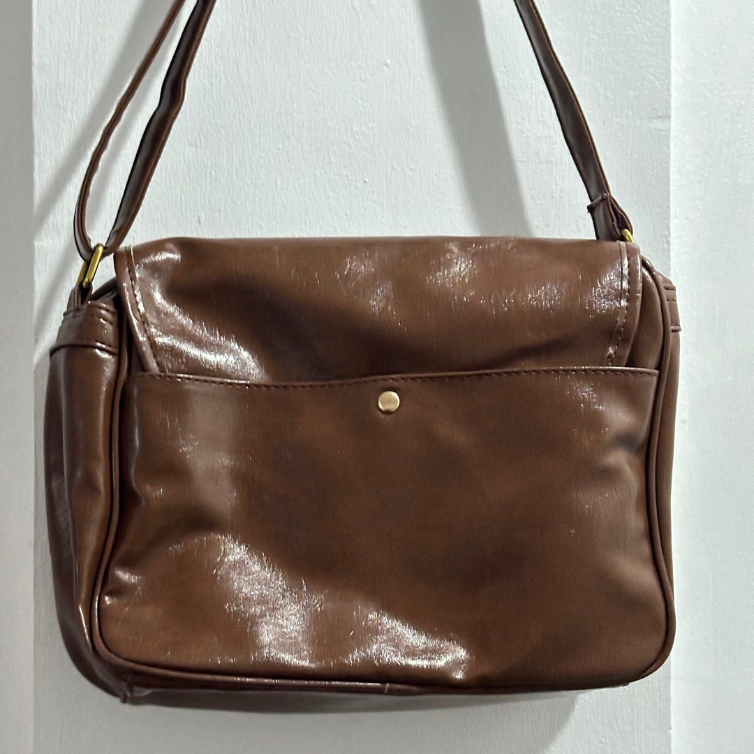 Dark Brown Shoulder/Cross body Bag (Category: Cross-body Bags) located in Binan City. Submitted by srdd_ (Listing ID 1326942928, Image 3). Description: For sale! - in mint condition - no scratches - with adjustable strap - lots of pockets - dust bag included - super nice color - good and convenient when travelling - can fit ipad, books, etc. Rfs: decluttering Mop: gcash / bpi / maribank.