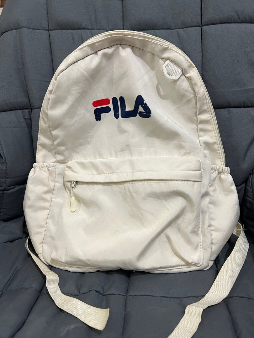 Fila white backpacks (Category: Backpacks) located in Makati City. Submitted by maltitalibrary (Listing ID 1326931737, Image 1). Description: Lightly used Backpack Details Color: white / off white Kind: backpack - Working straps - 2 pockets on the side - 1 zipper compartment in front - 1 pocket inside the main compartment - all zipper working ISSUE! May konting stains sa bag (not sure it matatanggal pag nilabahan) may fading ng konti sa name mism