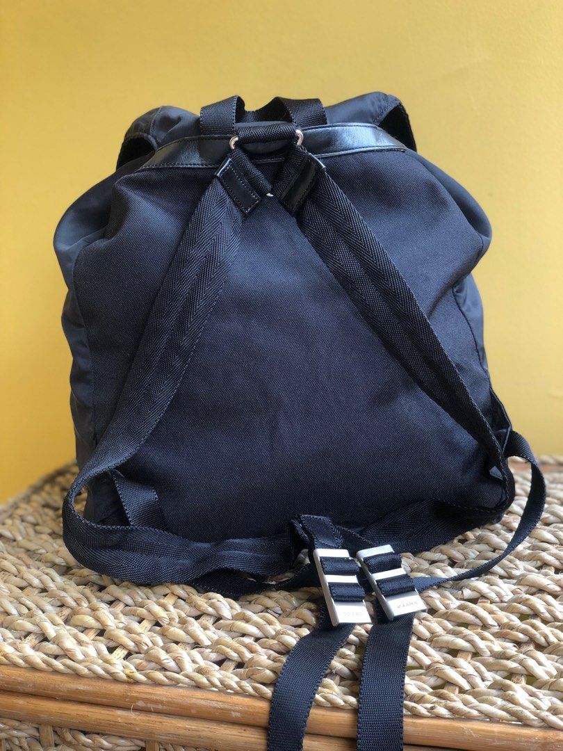 Vintage Prada Foldover Top Small Backpack (Category: Luxury Bags & Wallets) located in Pasig City. Submitted by thepearllabph (Listing ID 1327171748, Image 2). Description: Vintage Prada Backpack *Appearance 8/10 Color: black Model/Circa: Material: Nylon Pattern: plain Size: small Origin: Lining: hologrammed canvas Closure: magnetic, drawstring Hardwares: silver Compartments: 1 compartment, 1 inner pocket, 2 front pockets Features: ✓ Prada metal 