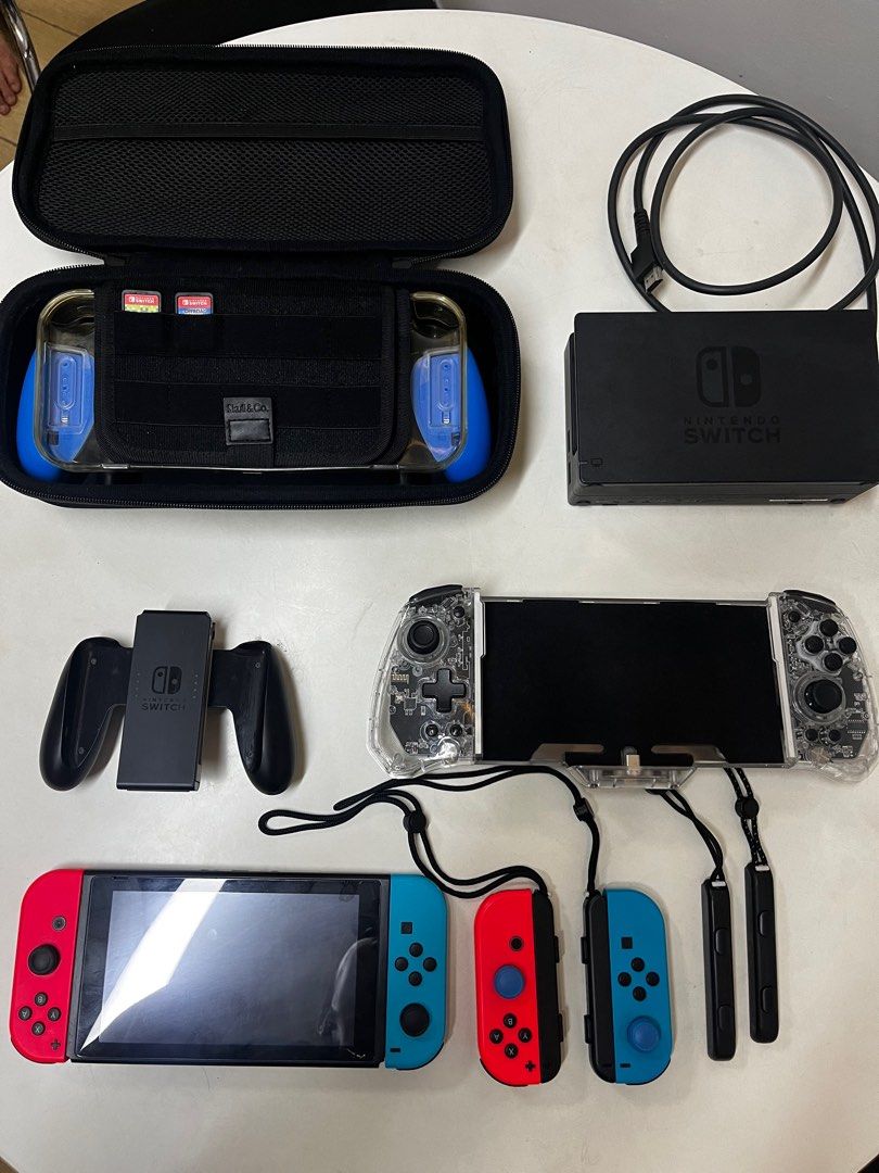 Nintendo Switch V2 (Category: Nintendo) located in Makati City. Submitted by jgurl4eva (Listing ID 1327345669, Image 1). Description: Nintendo switch v2 With orig charger With case With 2 extra controllers Charger dock of controllers (not in the photo) IINE switch handheld joy controller Everything in the photo 🎮 DM ME!!!.