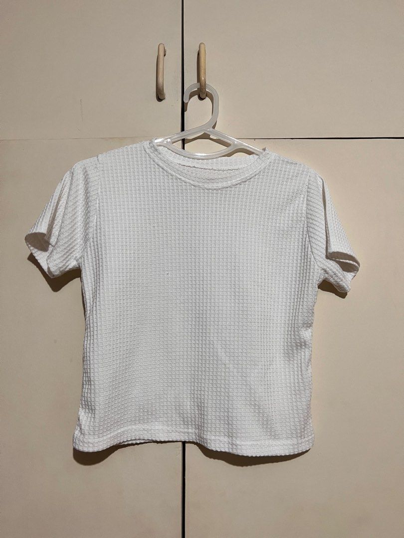Taytay White Waffle Shirt (Category: Shirts) located in Rizal. Submitted by nookstash (Listing ID 1327242089, Image 1). Description: Has a stain on collar and some loose threads! ✨ -FREE SIZE -Slightly Sheer Get this and another top of same price at ₱50!.