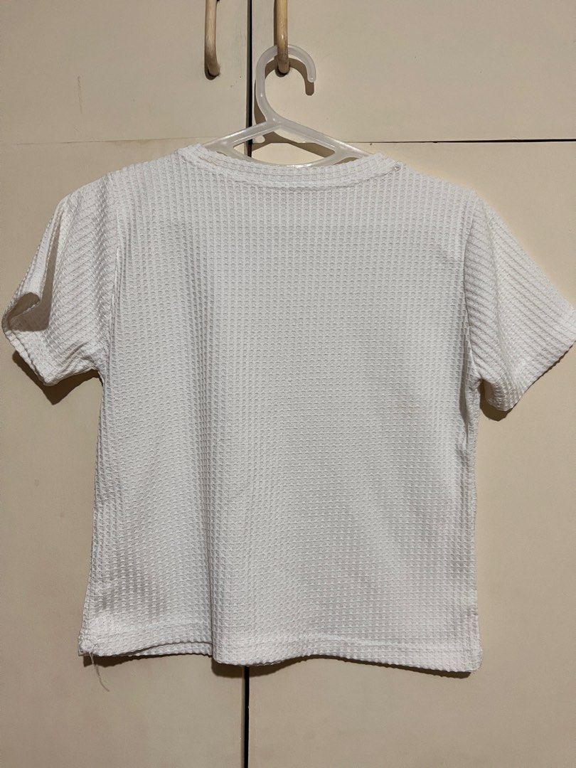 Taytay White Waffle Shirt (Category: Shirts) located in Rizal. Submitted by nookstash (Listing ID 1327242089, Image 2). Description: Has a stain on collar and some loose threads! ✨ -FREE SIZE -Slightly Sheer Get this and another top of same price at ₱50!.