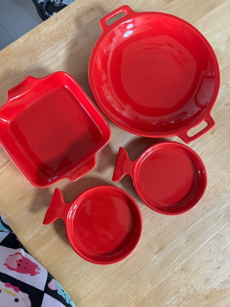 Red plates ceramic (Category: Dinnerware & Cutlery) located in Manila. Submitted by camshomecollections888 (Listing ID 1327415075, Image 1). Description: 1 shallow bowl 12 inches 1 Squre plate 9 inches 2 fish shape 71/2 inches Sizes handle to handle .