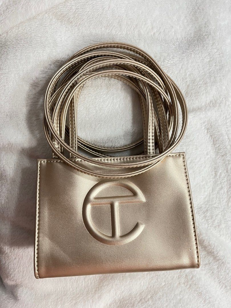 TELFAR Small Shopping Bag in Gold (Category: Luxury Bags & Wallets) located in Cainta. Submitted by sydkyn (Listing ID 1327418910, Image 3). Description: • brand: TELFAR • dimensions: Height - 4 3/4”, Width - 6 5/8”, Depth - 3”, Strap Drop - 21”, Handle Drop -4 3/4” • condition: 10/10 • note: NEVER BEEN USED. bought from the US. packaged in a drawstring bag with screen-printed logo. currently sold out in the official TELFAR website 😳 the iconic 