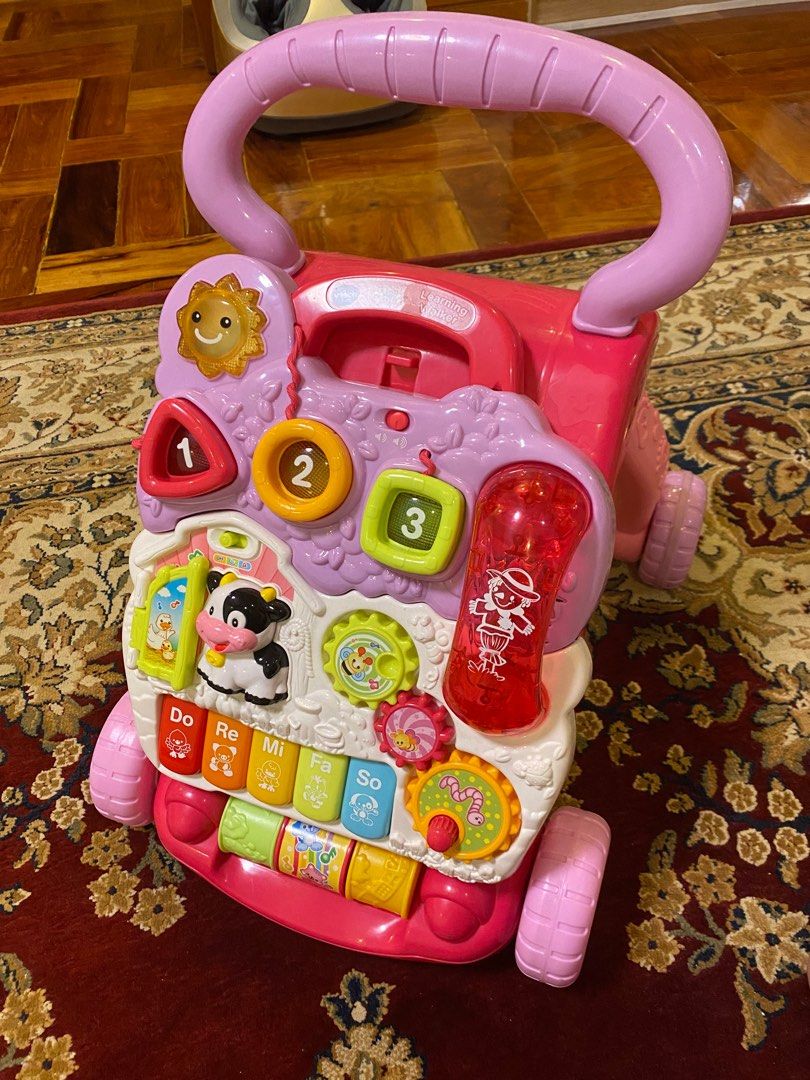 VTech Sit-to-Stand Learning Walker (Pink) (Category: Infant Playtime) located in Quezon City. Submitted by cdgextra (Listing ID 1327625676, Image 3). Description: Barely used! Still looks brand new. SRP 3,399 Recommended for ages 9 to 36 months Material: Plastic Adjustable speed control on wheels. Protects beginning walkers. Detachable learning centre introduces words, numbers, shapes, animals, and colours Contains a role-play mobile phone for ad