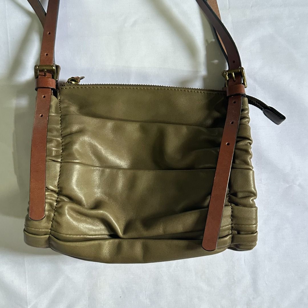 cotelac double strap bag (Category: Luxury Bags & Wallets) located in Manila. Submitted by rccdeclutters (Listing ID 1327760461, Image 3). Description: cotelac double strap bag dimensions: l = 8.5in w = 5in h = 7.5in material: lambskin features: - zipper closure - olive green color (color may vary due to lighting) - has one zipper pocket inside - has one zipper pocket in front of the bag (hidden) - strap adjustment - can fit mini umbrella + long 
