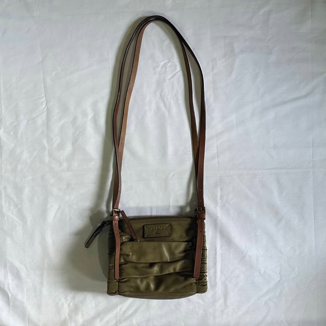 cotelac double strap bag (Category: Luxury Bags & Wallets) located in Manila. Submitted by rccdeclutters (Listing ID 1327760461, Image 2). Description: cotelac double strap bag dimensions: l = 8.5in w = 5in h = 7.5in material: lambskin features: - zipper closure - olive green color (color may vary due to lighting) - has one zipper pocket inside - has one zipper pocket in front of the bag (hidden) - strap adjustment - can fit mini umbrella + long 